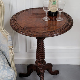 Rare early Victorian Irish Burr Walnut wine table. It has a beautiful carvings and a stunning burr walnut top, on a barley twist column and three shaped legs. It has been sourced locally and is in good original detailed condition. We also have a second table being sold separately which when together make a matched pair.