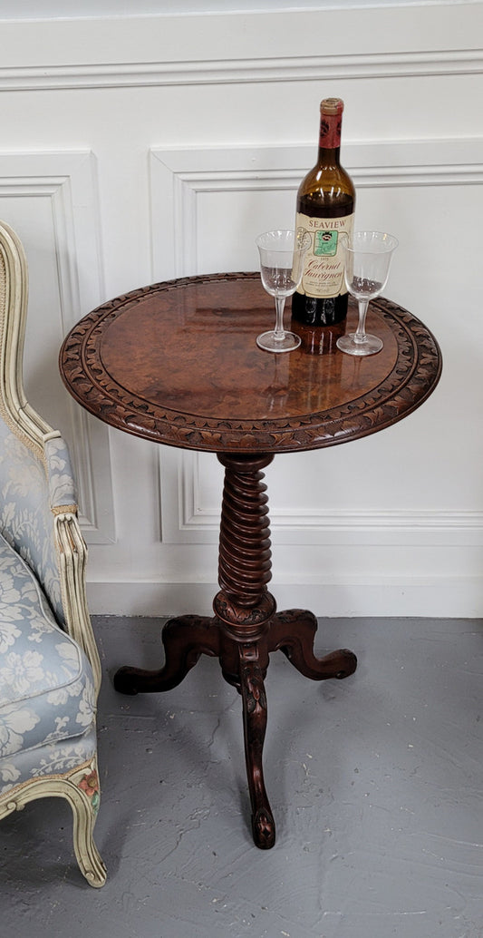Rare early Victorian Irish Burr Walnut wine table. It has a beautiful carvings and a stunning burr walnut top, on a barley twist column and three shaped legs. It has been sourced locally and is in good original detailed condition. We also have a second table being sold separately which when together make a matched pair.