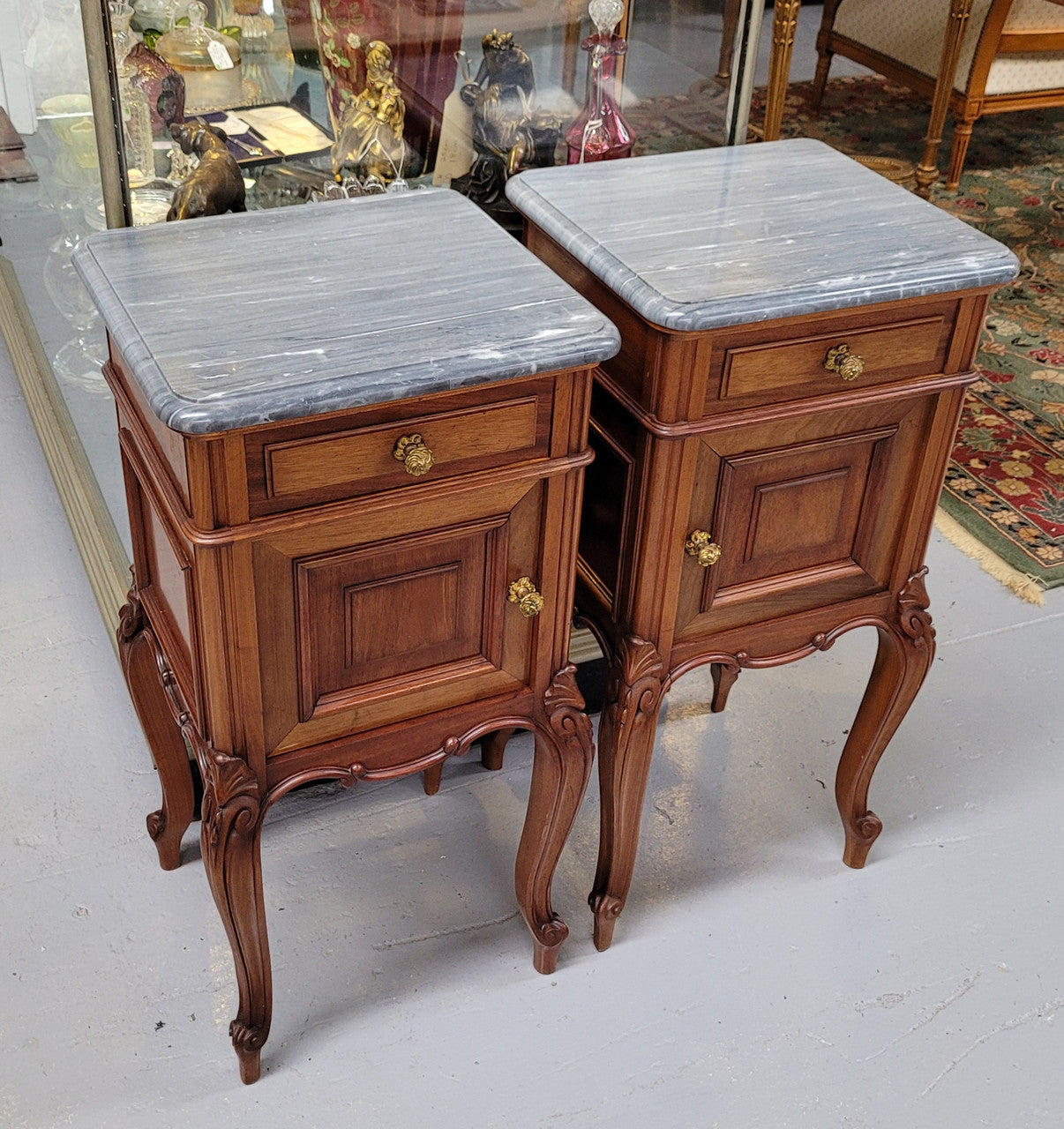 Pair of Walnut Louis XV style grey marble top bedside cabinets. Single drawer, one cupboard and lovely French cabriole legs. They have been sourced from France and are in good original condition.