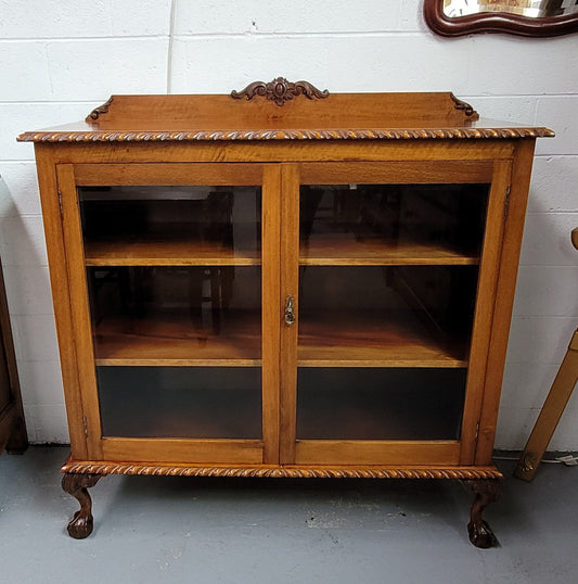 Chippendale style Mahogany two door bookcase. It has bevelled glass doors and two adjustable shelves. It has been sourced locally and is in good original detailed condition.