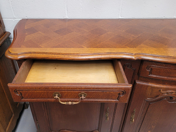 French Oak Louis XV style three drawer three door parquetry top sideboard. It has been sourced from France and is in good original detailed condition.