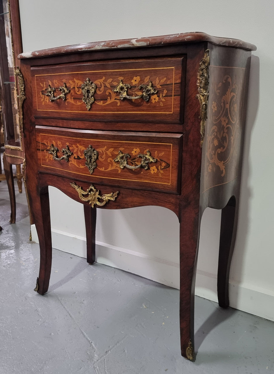 A stunning French petite two drawer inlaid Rosewood commode. In good original detailed condition.