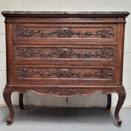 French Oak Louis XV style marble top chest of three drawers. It has beautiful carvings on the drawers with lovely decorative handles all toped with a stunning black and white marble top. In good original detailed condition.