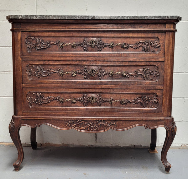 French Oak Louis XV style marble top chest of three drawers. It has beautiful carvings on the drawers with lovely decorative handles all toped with a stunning black and white marble top. In good original detailed condition.