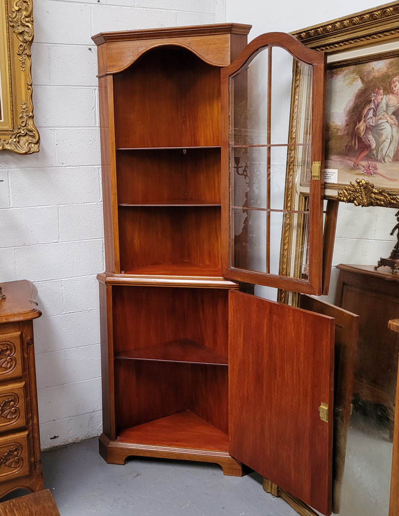 Practical Walnut corner cabinet with display and storage. Two shelf glass display on top and single shelf cupboard below. Sourced locally and in good original detailed condition.