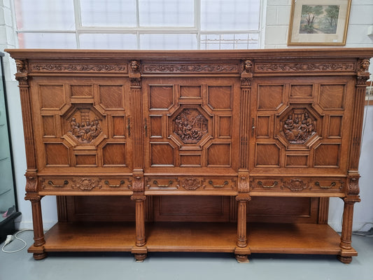 Impressive and grand French Oak Renaissance style sideboard. Beautifully detailed carvings and plenty of storage with three very large cupboards with a total of eight adjustable shelves along with three large drawers. It has been sourced from France and is in very good original detailed condition.