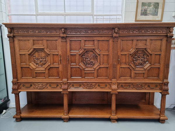 Impressive and grand French Oak Renaissance style sideboard. Beautifully detailed carvings and plenty of storage with three very large cupboards with a total of eight adjustable shelves along with three large drawers. It has been sourced from France and is in very good original detailed condition.