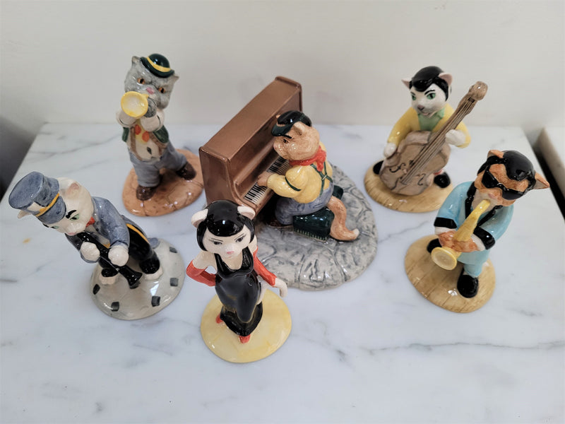 Amazing Beswick cat band figurines. There are 6 figurines including Fat Cat (Piano), Purrfect Pitch, Trad Jazz Tom, Rathcatcher Bilk, One Cool Cat and Cat Walking Bass. They are all in excellent original condition.