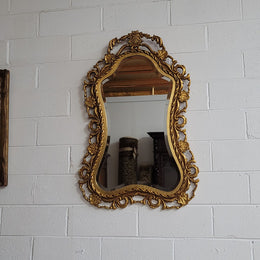 Large Vintage Italian carved wood gilt mirror. It has a beautiful bevelled mirror and has been sourced from France. It is in good original condition.