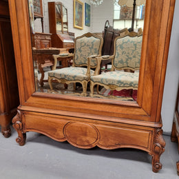 French Louis XV style Walnut armoire with single bevelled mirrored door. It has four adjustable shelves and a hidden exterior drawer at the bottom. It has been sourced from France and is in good original detailed condition.