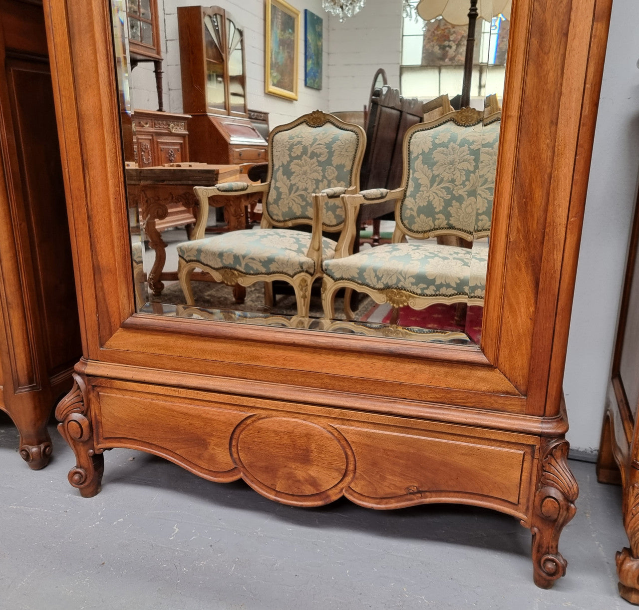 French Louis XV style Walnut armoire with single bevelled mirrored door. It has four adjustable shelves and a hidden exterior drawer at the bottom. It has been sourced from France and is in good original detailed condition.