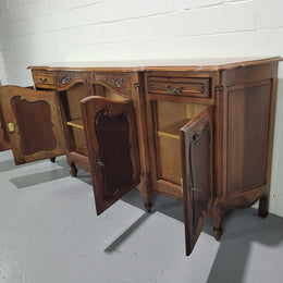 Walnut Louis XV style parquetry top four door sideboard with beautiful carving. Plenty of storage space and it is in good original detailed condition.