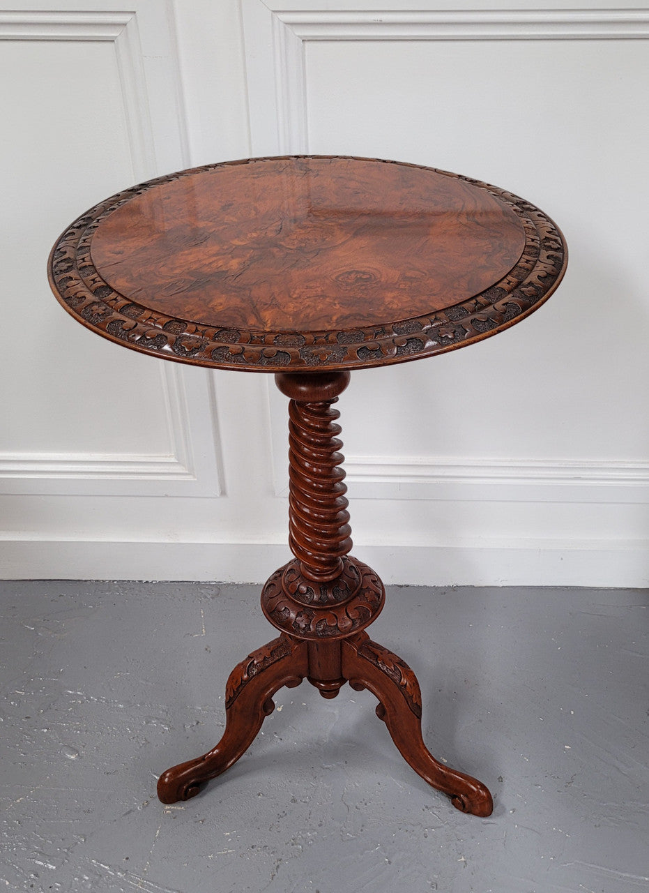 Rare early Victorian Irish Burr Walnut wine table. It has a beautiful carvings and a stunning burr walnut top, on a barley twist column and three shaped legs. It has been sourced locally and is in good original detailed condition. We also have a second table being sold separately which when together make a matched pair.