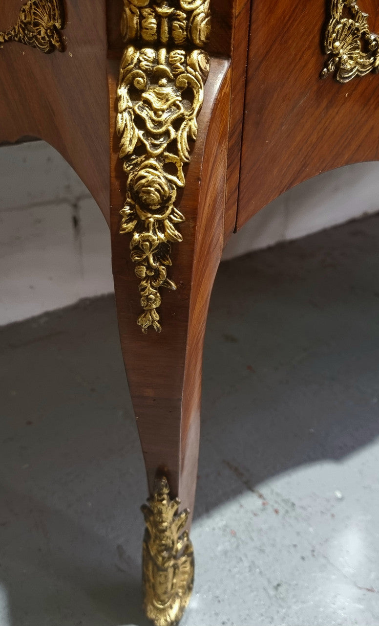 Stunning transitional French Marquetry inlaid marble top commode. It has lovely ormolu decorative mounts and an amazing thick marble top. Sourced from France and is in good original detailed condition.