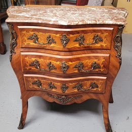 Antique French Louis XV style compact three drawer marble top commode with marquetry inlay and ormolu mounts. Sourced from France and in good original detailed condition.