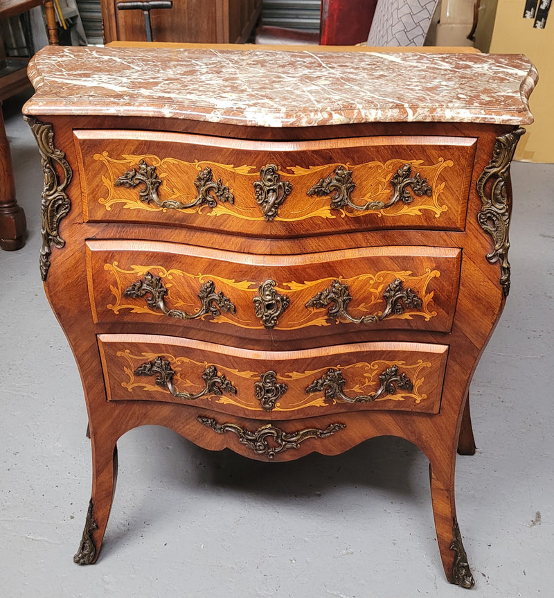 Antique French Louis XV style compact three drawer marble top commode with marquetry inlay and ormolu mounts. Sourced from France and in good original detailed condition.