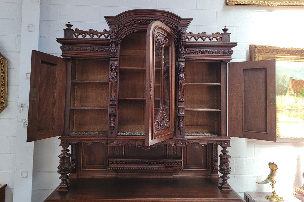 Spectacular French Walnut Renaissance Style buffet with amazing detailed carvings. Plenty of storage space with five cupboards and two large drawers. The three top cupboards open up to two adjustable shelves in each section and the two bottom drawers open up to one large fully adjustable shelve. In good original detailed condition.