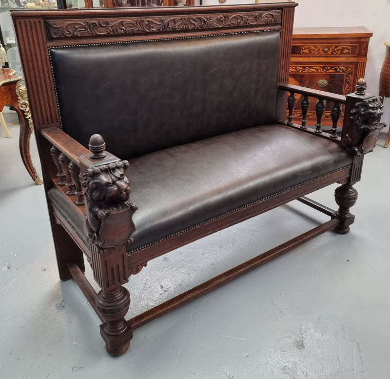 Superbly carved early 19th century newly upholstered French Oak hall seat of grand proportions and lovely details in good condition.