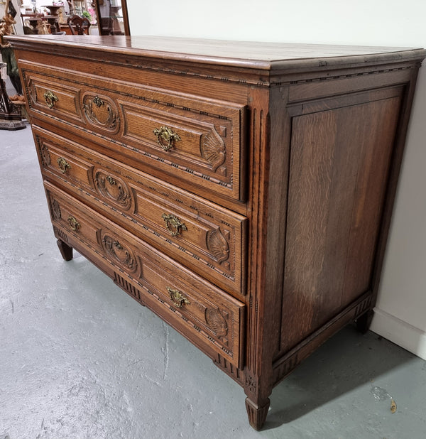 Early 19th Century French Oak chest of three drawers. It has beautiful handles and carvings. It is in good original detailed condition.