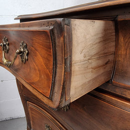 Impressive French Louis XV style Cherrywood four drawer commode, with a wooden top, two large drawers and two smaller drawers. Features attractive handles and a carved skirt and feet. In good original detailed condition.