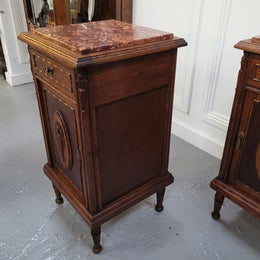 Pair of French Art Deco Oak and rouge inset marble top bedside cabinets. They have one drawer and one cupboard with elegant carving on the door. They have been sourced from France and are in good original detailed condition.