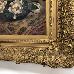 An Antique gilt-framed oil painting of floral still life. Housed in a double sweep gilt frame, signed and dated in good condition.