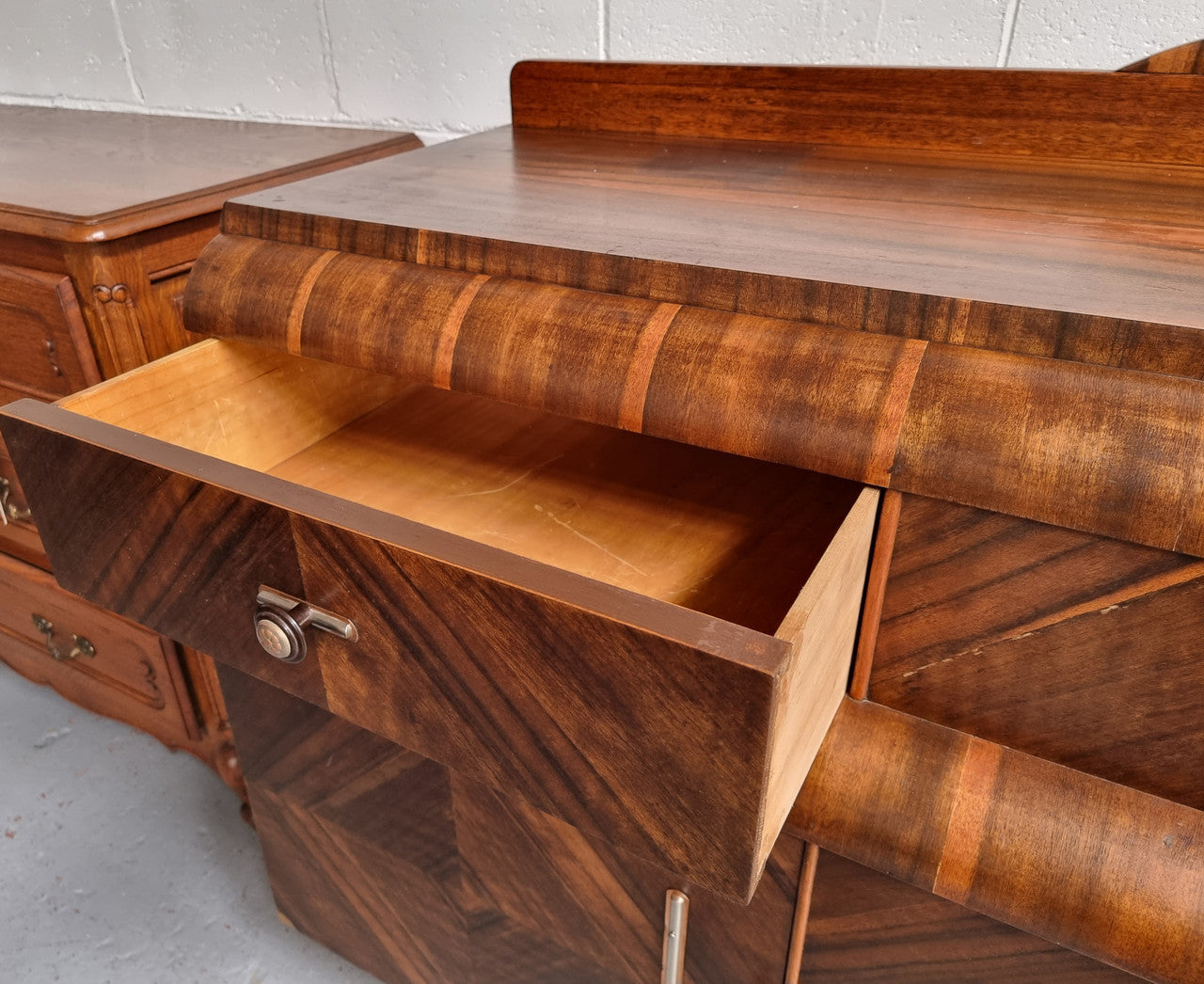 Vintage Walnut Art Deco “Waterfall” sideboard buffet with two drawers and two doors. It is in good original condition and has been sourced locally.