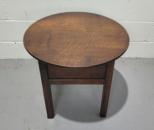 Fabulous round oak side table which also has a hidden sewing box underneath with lovely original blue satin lining and Includes pictured sewing items. It is in good original condition.