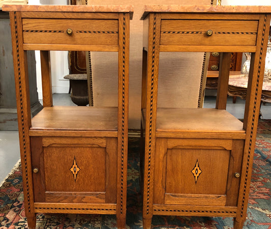 Beautiful pair of French Oak inlaid bedside cabinets with marble tops and a drawer and cupboard for all your storage needs in good original condition.