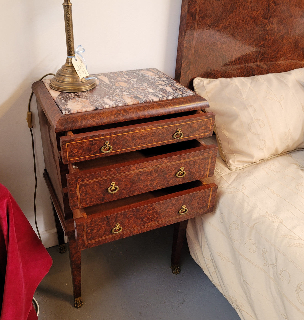 French Art Deco bedroom suite consisting of queen size bed in Amboyna wood and featuring pretty inlay. It comes with a matching pair of bedsides. It is a very stylish and high quality suite. It has been sourced from France and is in good original detailed condition.