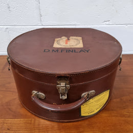 Charming solid leather hatbox with patterned fabric interior and two interior pockets. Interior stamp is for The Mutual Store Melbourne. Bears paper stamps for P&O Cruise Passenger” & “Peninsular  the top and D.M.F. in gold near the handle. Circa: Early 1900’s. 43 cm across and H:21 cm the lid.