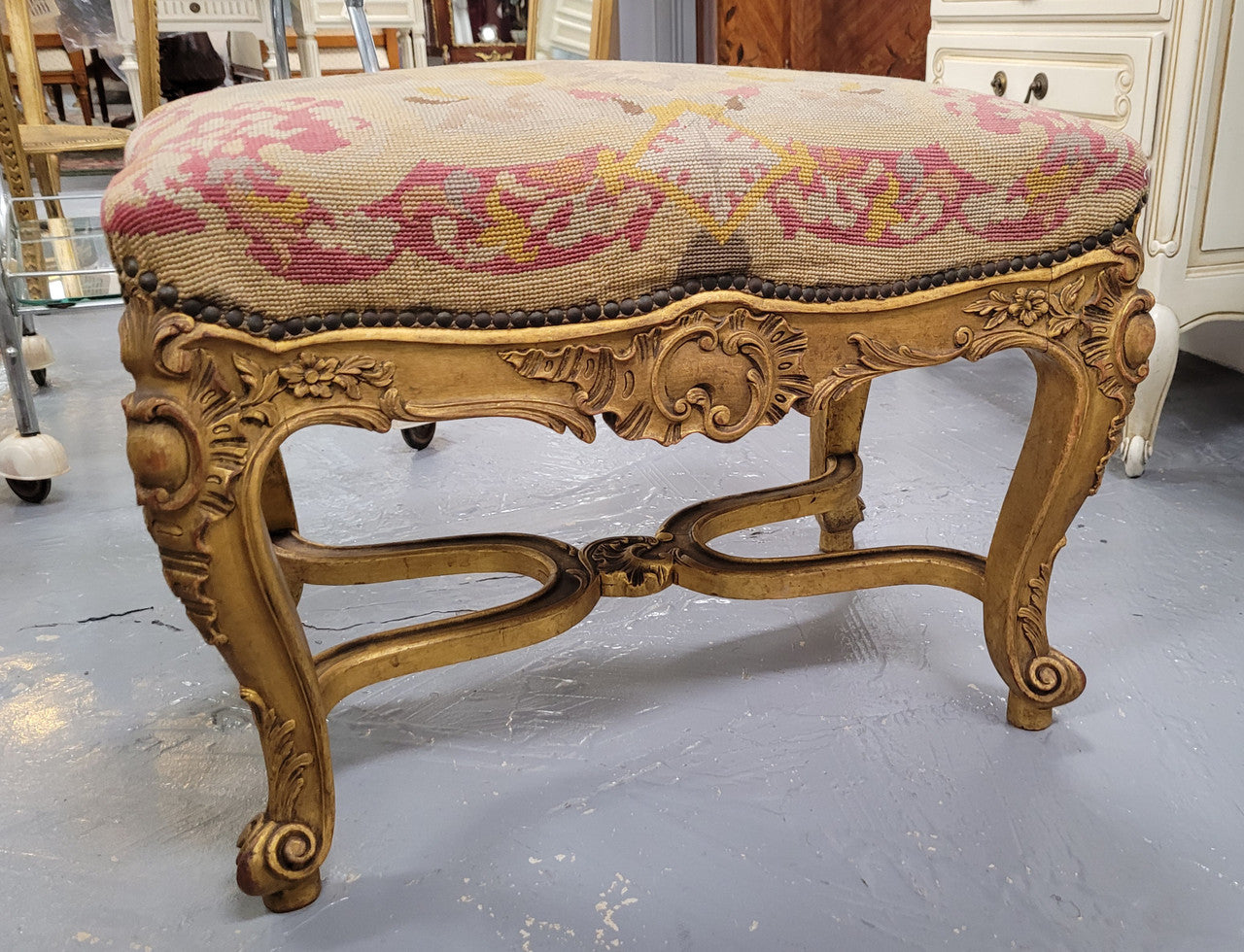 Charming 19th Century gilt wood tapestry covered Louis XV style stool. It has a beautifully carved base and undercarriage and it has been sourced from France. It is in good original detailed condition, please view photos of tapestry has they help form part of the description.