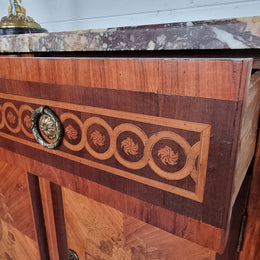 A high quality 19th Century French marquetry inlaid Kingwood marble top credenza. It has an attractive solid marble top and decorative marquetry inlay throughout. It has plenty of storage space with three drawers and three doors. It has been sourced from France and is in good original detailed condition.