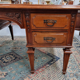 Substantial French Louis XVI style Oak partners desk. It has a beautiful leather top, two drawers on either side and decorative carvings throughout. Sourced from France and in good original detailed condition.