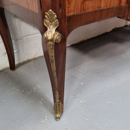 A stunning French transitional Louis XV and Louis XVI style commode. It has beautiful walnut inlay and a fabulous marble top. Comes with two drawers and fitted with gilt brass mounts. it is In very good original condition.