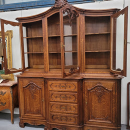 Impressive French Oak Louis 14th Style Display and Sideboard. It has 4 drawers, 2 bottom cupboards with 6 total shelves and 3 display doors with 3 shelves.  In good, detailed condition.
