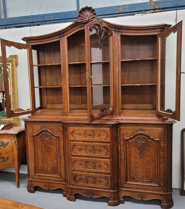 Impressive French Oak Louis 14th Style Display and Sideboard. It has 4 drawers, 2 bottom cupboards with 6 total shelves and 3 display doors with 3 shelves.  In good, detailed condition.