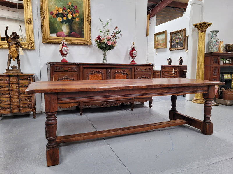 Charming solid rustic Oak stretcher base Farmhouse table. The table is circa 1950's and was custom made using reclaimed oak. It comfortable sits eight and could seat 10. It is in good original detailed condition.