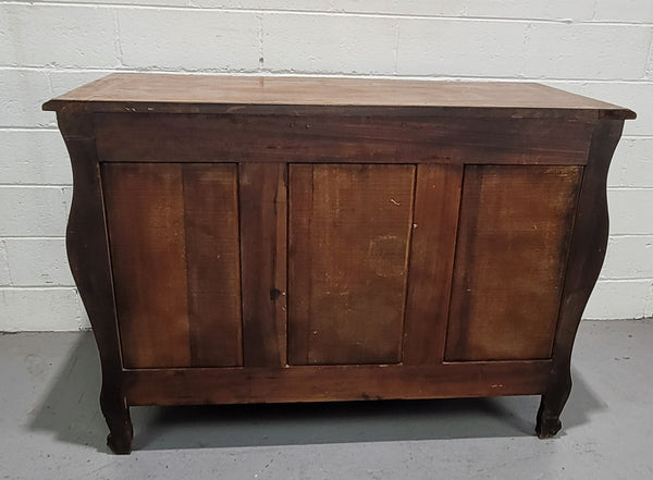 French Walnut Louis XV style five drawer commode. It has a beautiful wooden top and is beautifully carved. It is in good original detailed condition.
