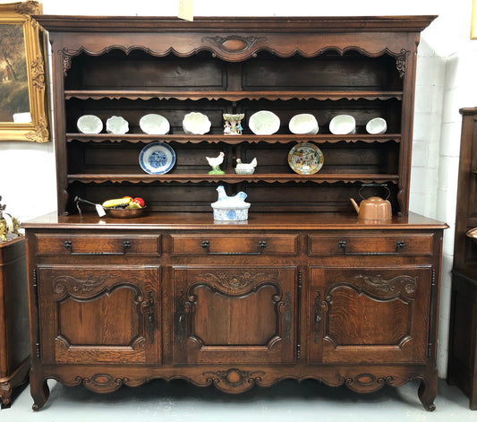 Grand 19th century Oak French kitchen dresser. A beautiful very practical piece with loads of storage havings three large shelves, three large drawers and three shelves for displaying items. It has been sympathetically restored and is in good detailed condition.