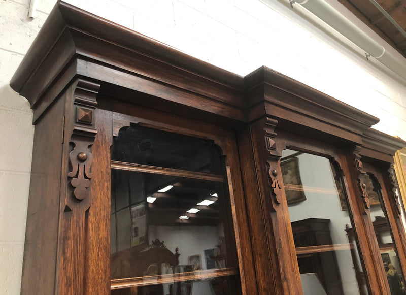 Amazing six-door Oak English bookcase sourced from France. The top section has adjustable shelves and plenty of storage space below which has fixed shelves. Keys and locks in working condition. In good original detailed condition. Circa 1880.