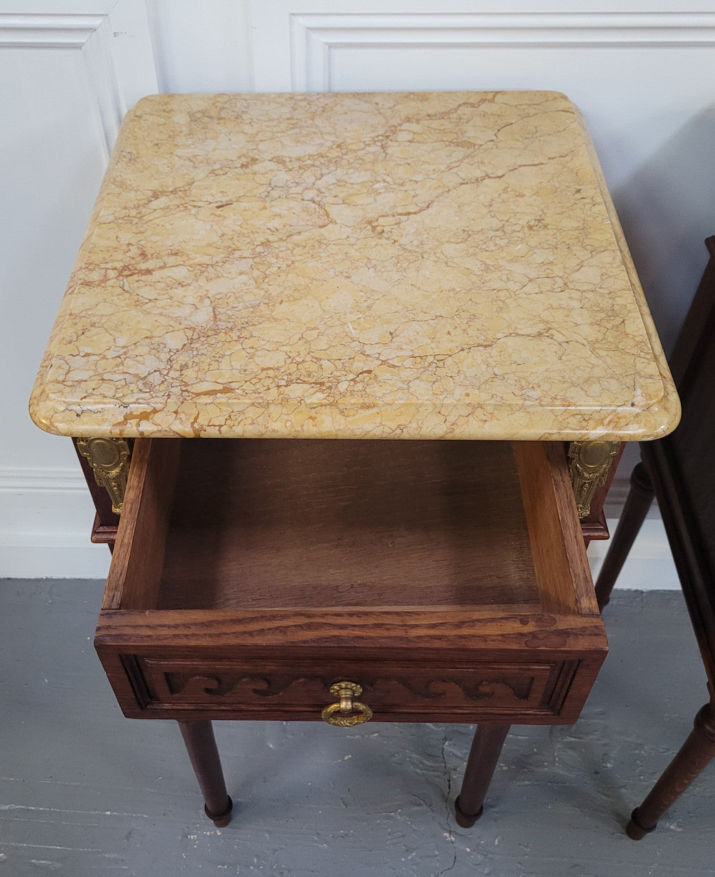 French Oak pair of Louis 16th style marble top bedsides with stunning bronze mounts. They have been sourced from France and are in good original detailed condition.