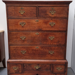 Early 19th Century English Oak chest on stand. It has been sourced in France and has plenty of storage space with eight drawers. In good original detailed condition.