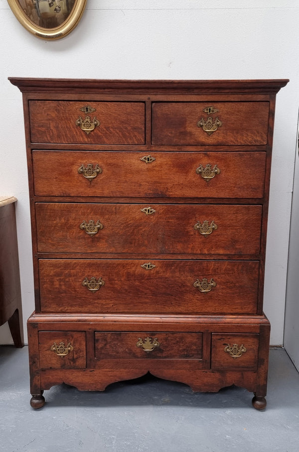 Early 19th Century English Oak chest on stand. It has been sourced in France and has plenty of storage space with eight drawers. In good original detailed condition.