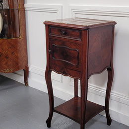 French Rosewood inset marble top single bedside cabinet with one drawer and one cupboard on elegant legs. Would also make a practical and stunning table lamp. It is in good original detailed condition.