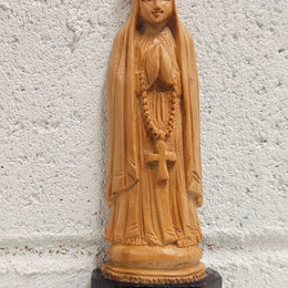 Vintage Olivewood statue of praying Virgin Mary on dark wooden plinth. Condition comensurate with age, please view photos as they help form part of the description.