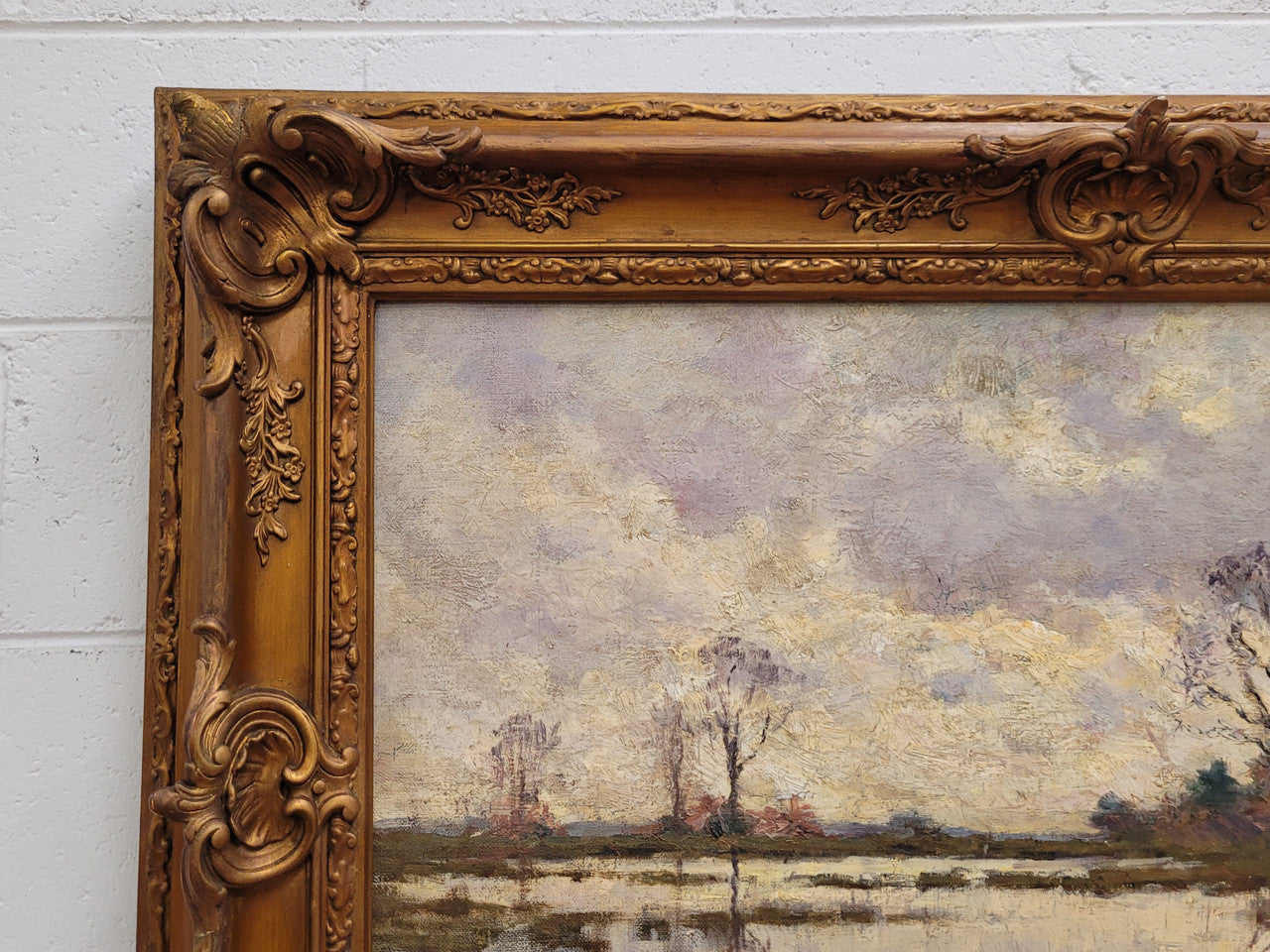 Sourced from France an impressionist oil painting of a beautiful lake scene. It is nicely framed in an Antique frame and in good original detailed condition.