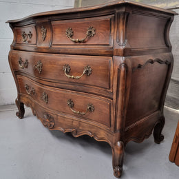 Impressive French Louis XV style Cherrywood four drawer commode, with a wooden top, two large drawers and two smaller drawers. Features attractive handles and a carved skirt and feet. In good original detailed condition.