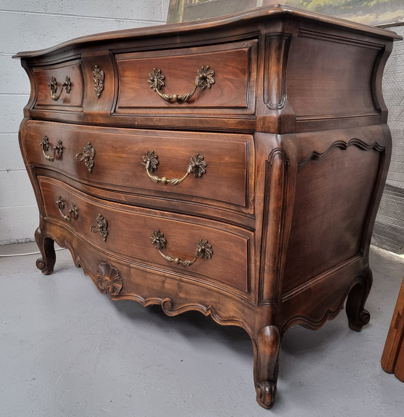 Impressive French Louis XV style Cherrywood four drawer commode, with a wooden top, two large drawers and two smaller drawers. Features attractive handles and a carved skirt and feet. In good original detailed condition.