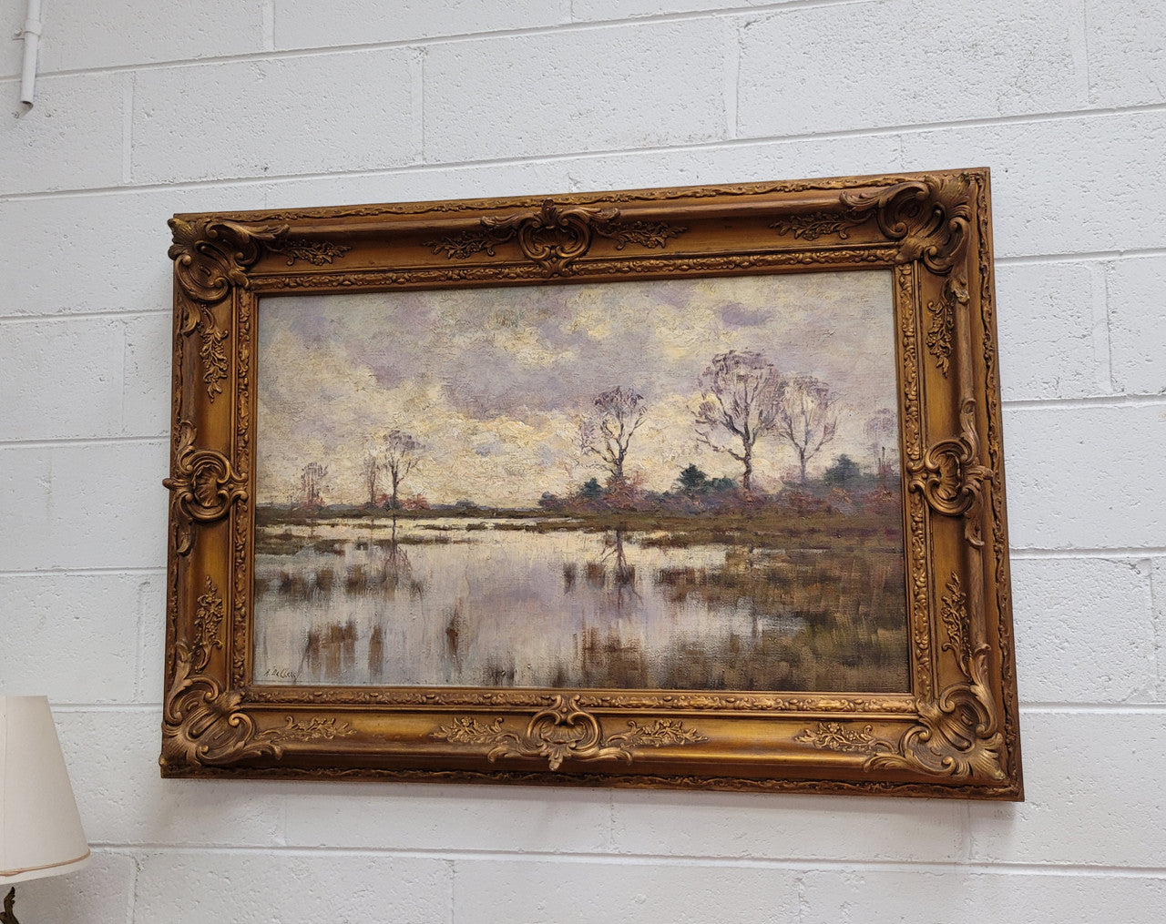 Sourced from France an impressionist oil painting of a beautiful lake scene. It is nicely framed in an Antique frame and in good original detailed condition.